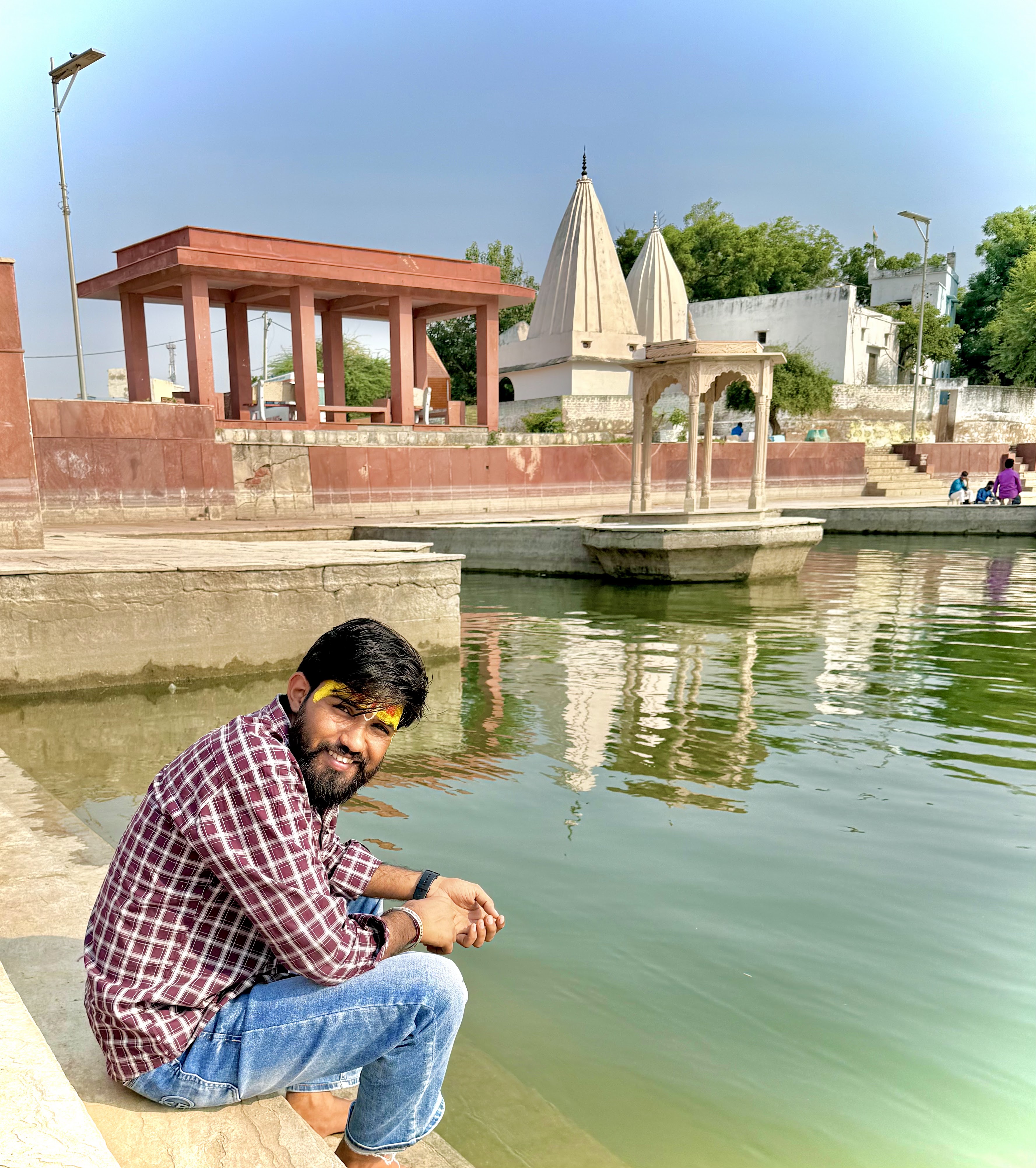 Rahul Gurjar by a riverside temple